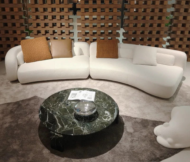 Cream curved sofa with leather cushions