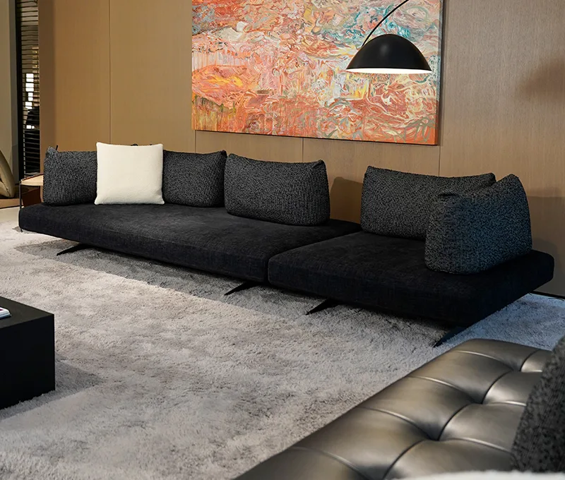 Black low sofa with patterned cushions